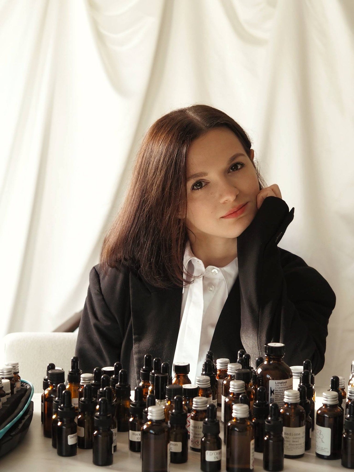 The OZORNINA perfumer at her table of fragrance ingredients